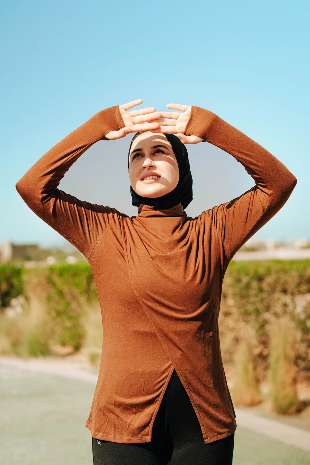 Woman doing battle rope training in industrial gym setting, showcasing high-intensity functional fitness and purposeful movement
